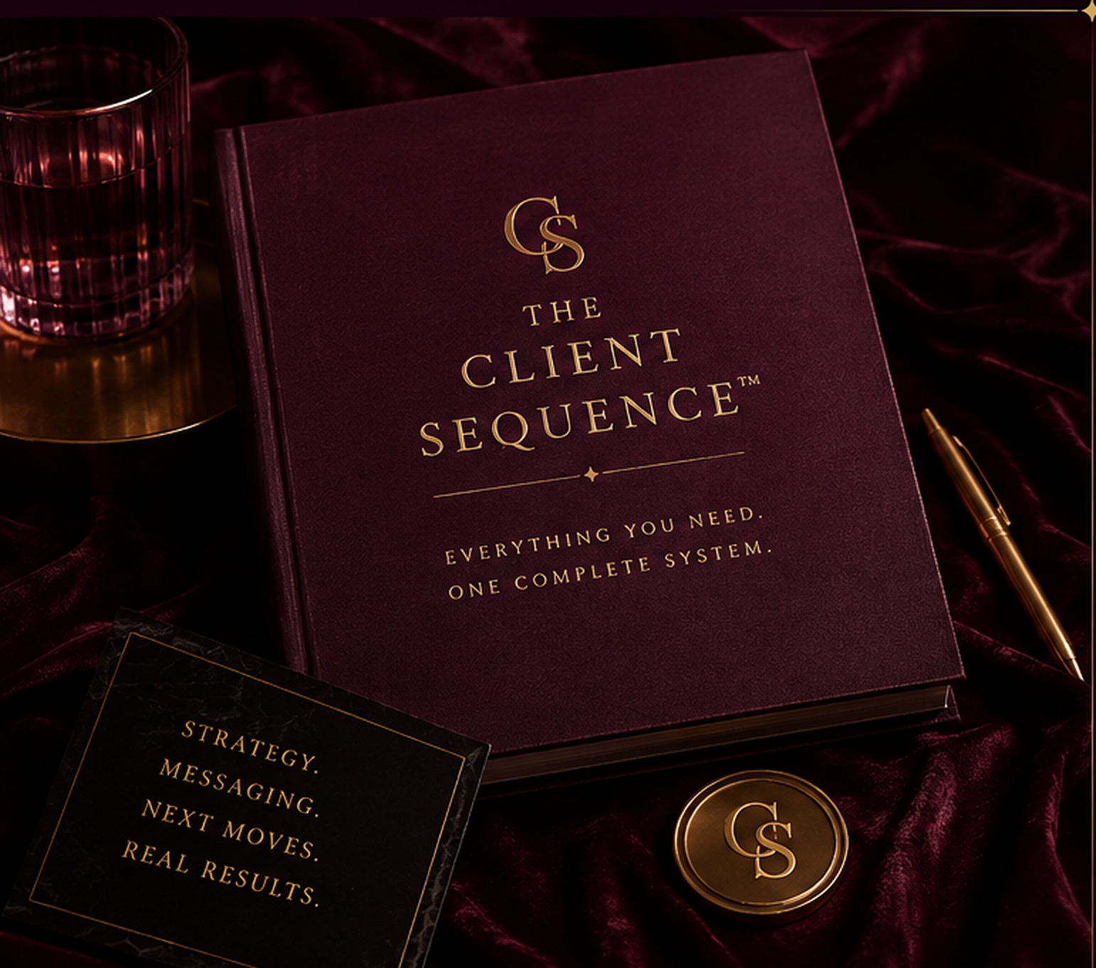 Burgundy book with gold CS monogram on velvet, gold pen and amber glass
